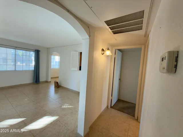 a view of a hallway with chandelier