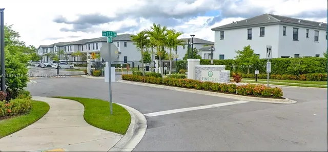 a front view of multiple houses with yard