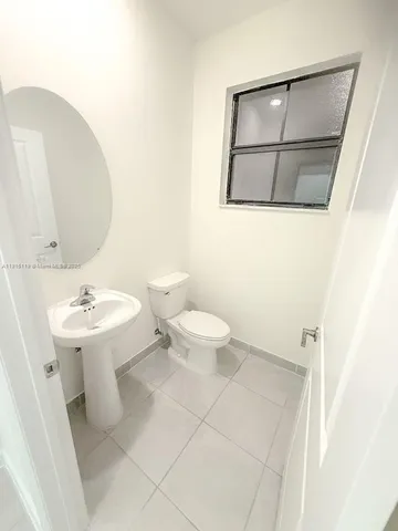 a bathroom with a sink a mirror and a toilet