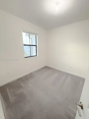 an empty room with a windows
