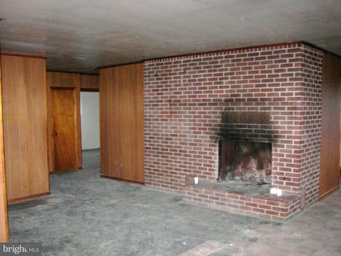 472 Sherrill Berkeley Springs Berkeley Springs, WV 25411 - Photo 12 of 18 a view of empty room with a fireplace