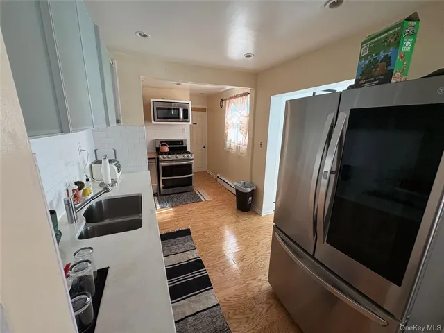 a kitchen with stainless steel appliances a refrigerator and a stove top oven