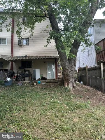 a view of a house with large trees