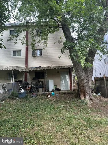 a couple of table and chairs in front of house