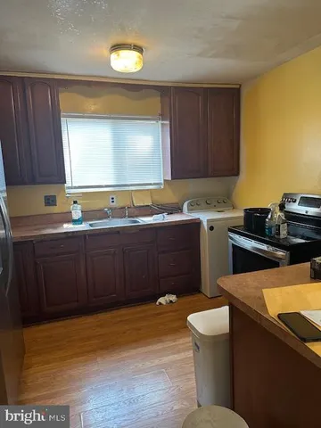 a kitchen with a sink and wooden cabinets