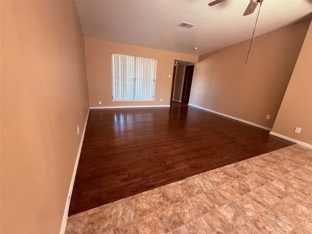 a view of interior space with wooden floor and window
