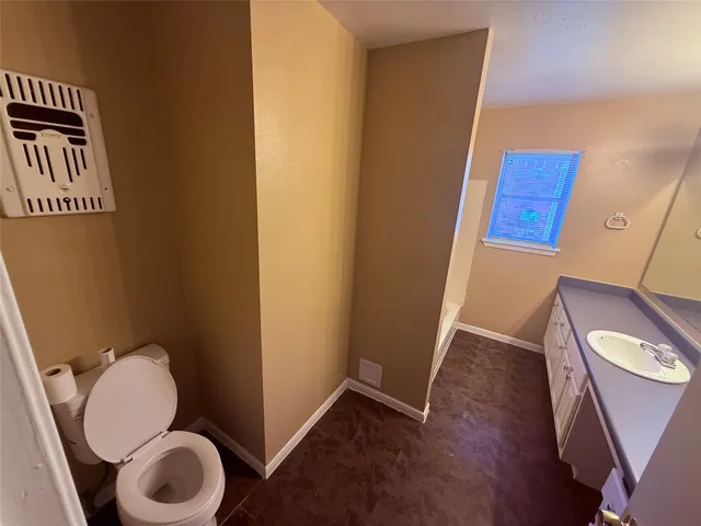 a bathroom with a toilet and a mirror