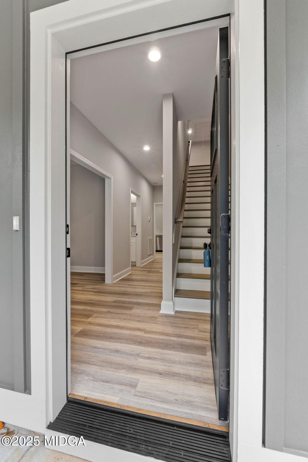 2760 Boxankle Road Forsyth, GA 31029 - Photo 3 of 50 a view of a hallway with wooden floor and staircase