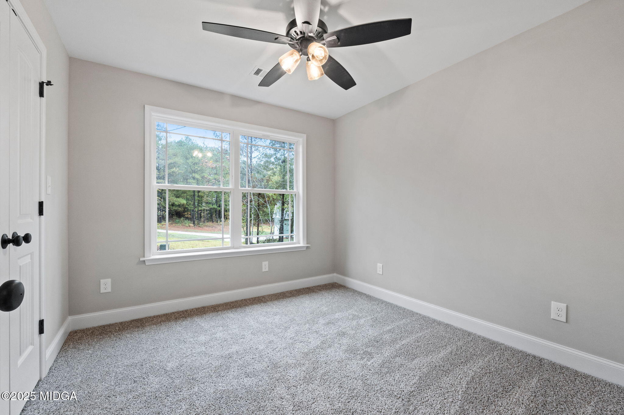 2760 Boxankle Road Forsyth, GA 31029 - Photo 31 of 50 an empty room with windows and fan