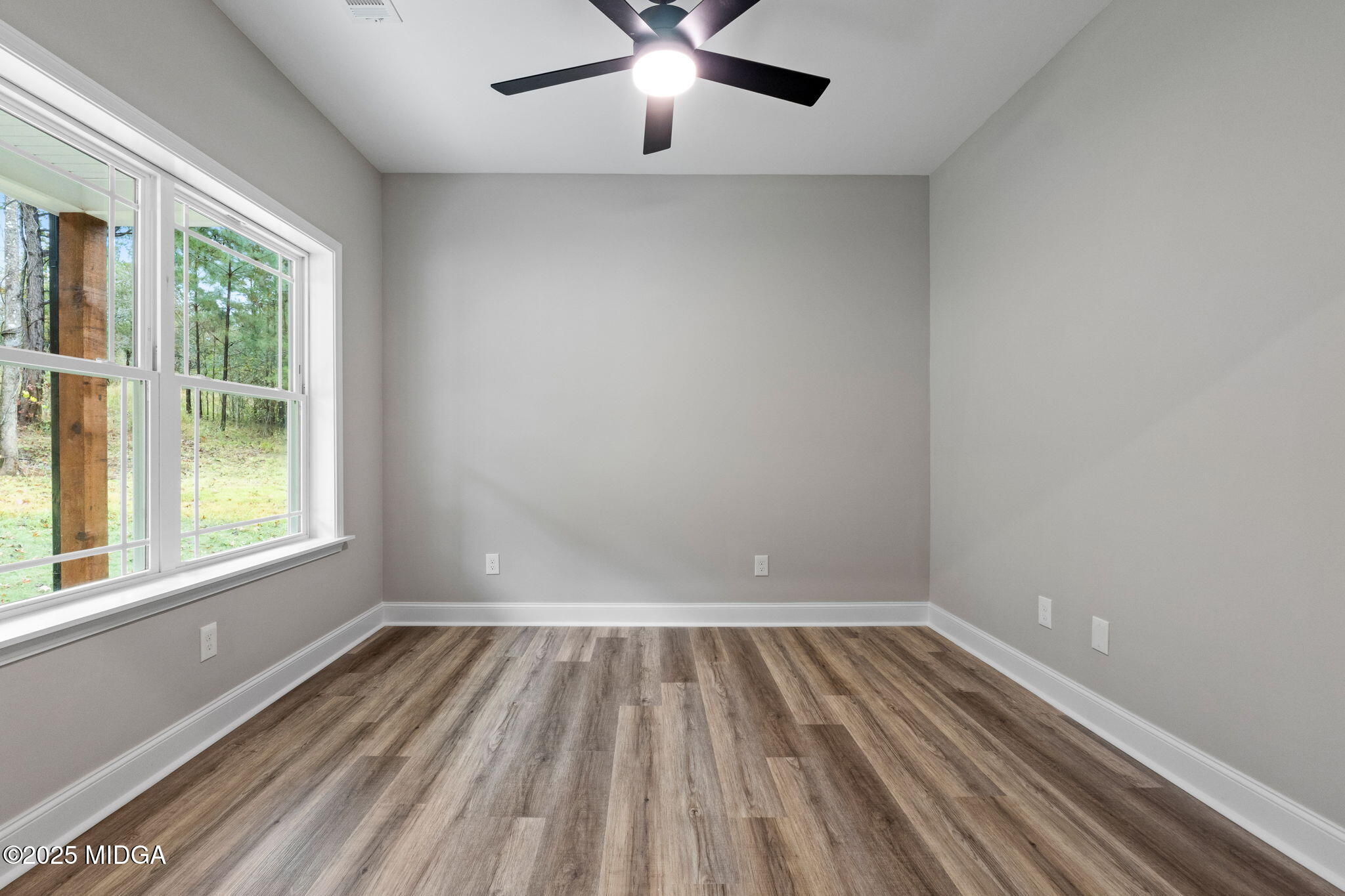 2760 Boxankle Road Forsyth, GA 31029 - Photo 5 of 50 wooden floor in an empty room with a window