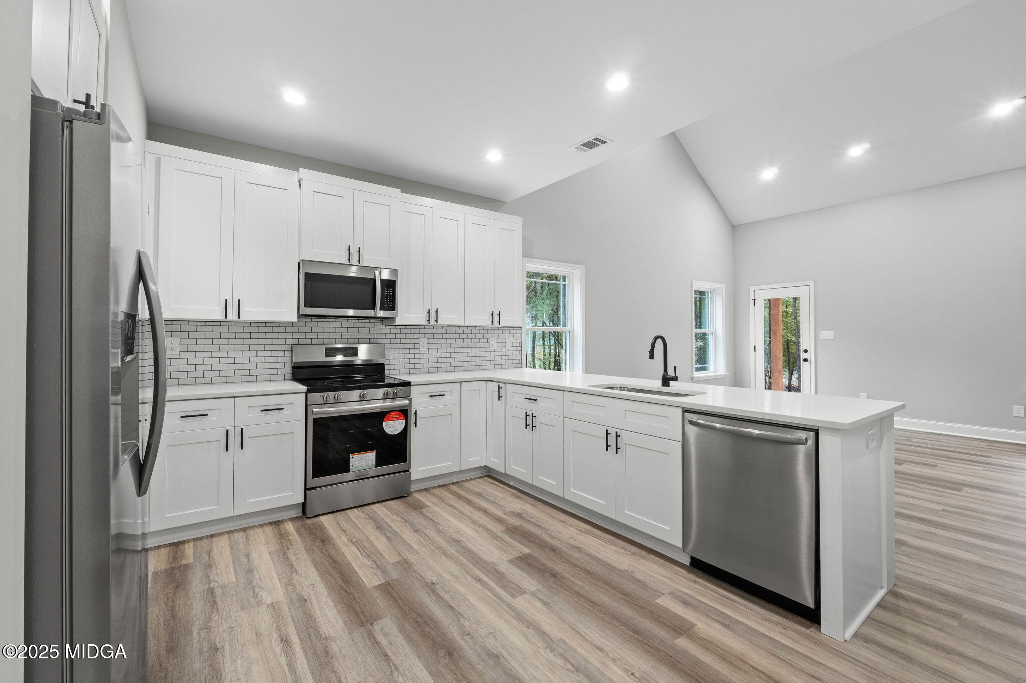 2760 Boxankle Road Forsyth, GA 31029 - Photo 9 of 50 a kitchen with a sink stainless steel appliances and white cabinets