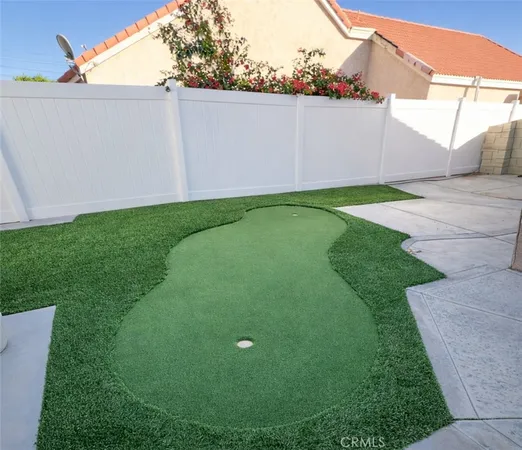 a white house with a yard and a sink