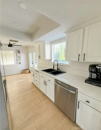 a large white kitchen with a sink