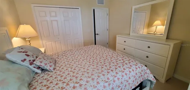 a bedroom with a bed and a dresser