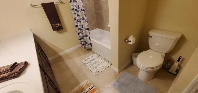 a white toilet sitting next to a bathroom sink