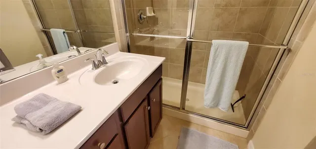 a bathroom with a sink a mirror and shower