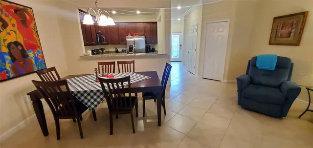 a view of a dining room with furniture and a chandelier