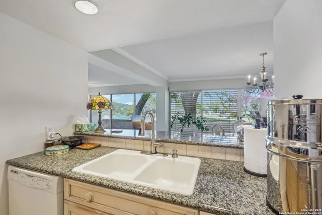 a living room with granite countertop furniture and a floor to ceiling window
