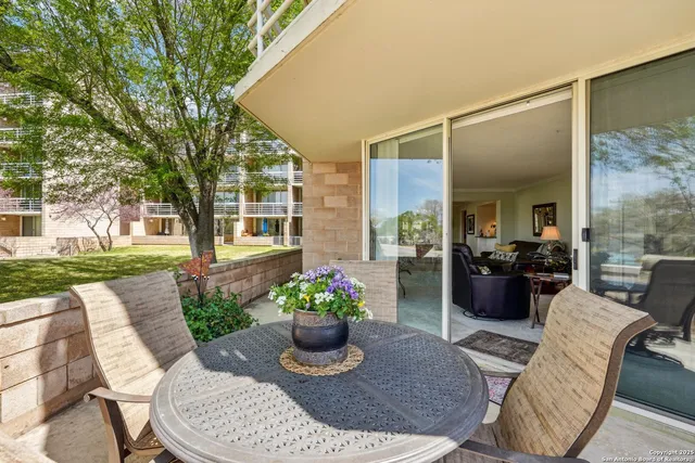 a view of a patio with couches table and chairs and potted plants