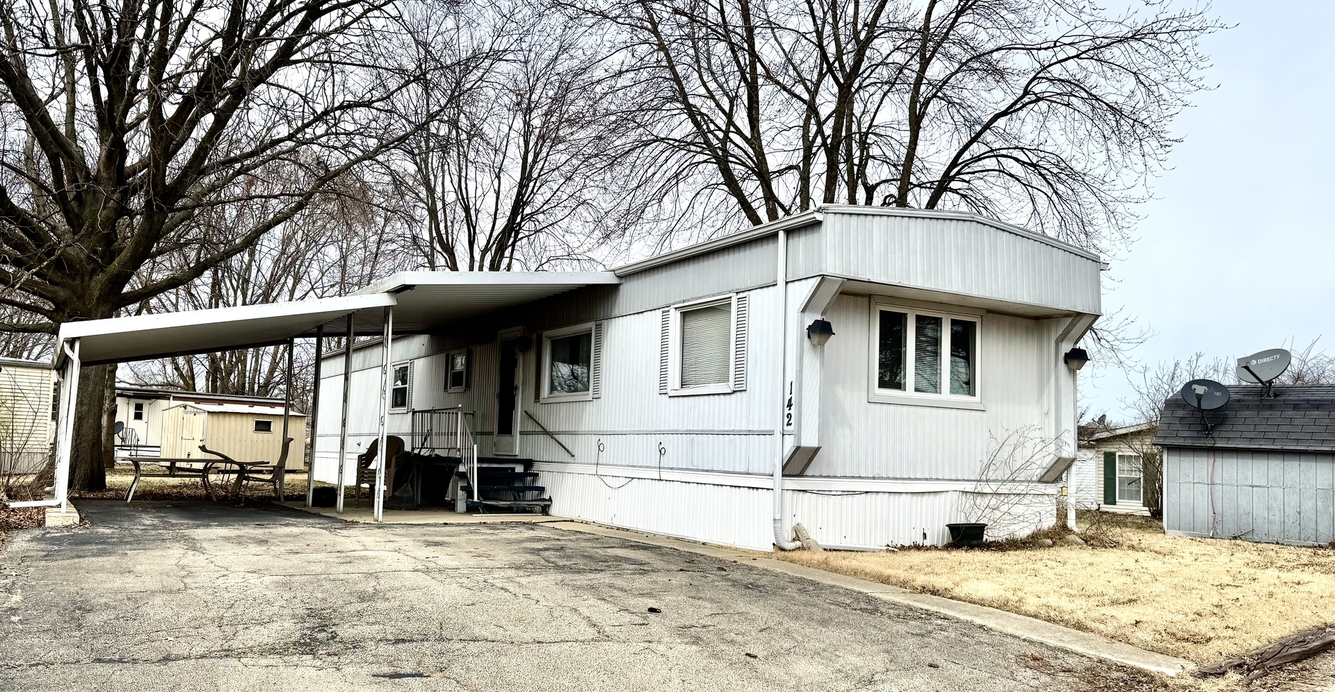 a view of a house with a large tree