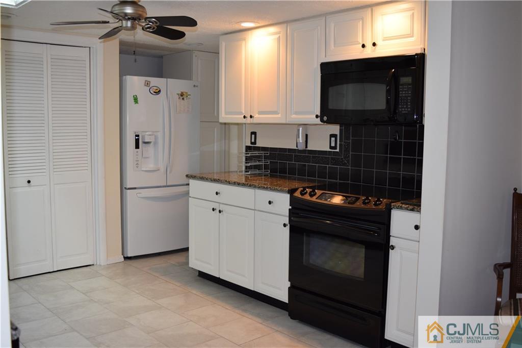 274 A Convent Road Monroe Township, NJ 08831 - Photo 5 of 12 a kitchen with stainless steel appliances a stove a microwave and a refrigerator