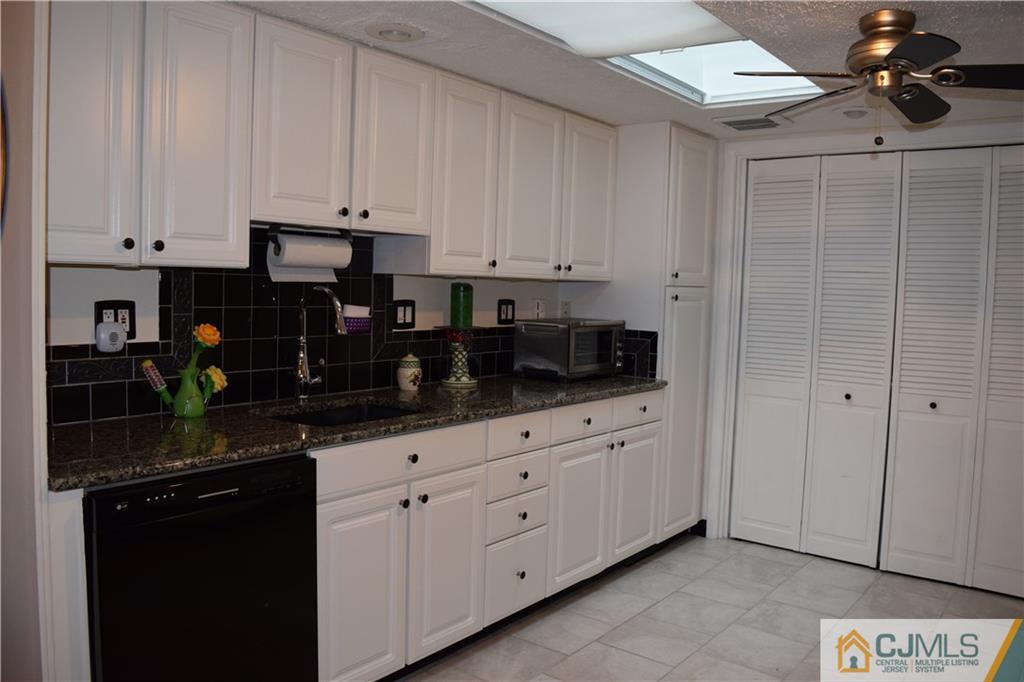 274 A Convent Road Monroe Township, NJ 08831 - Photo 6 of 12 a kitchen with white cabinets and sink