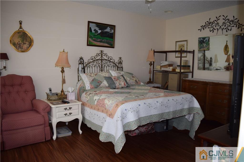 274 A Convent Road Monroe Township, NJ 08831 - Photo 7 of 12 a bedroom with a bed and a chandelier