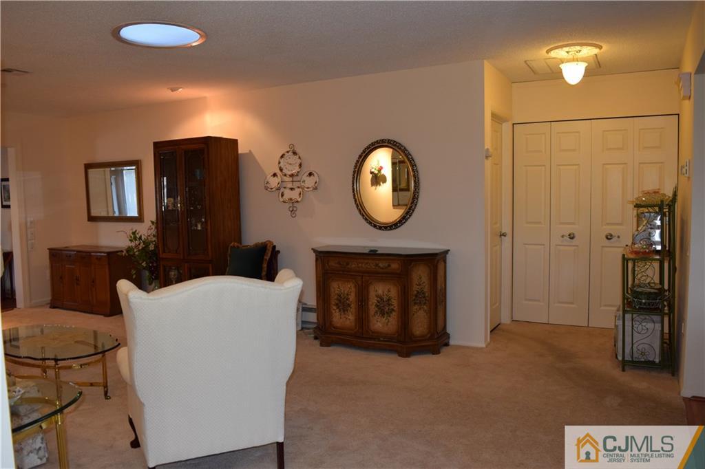 274 A Convent Road Monroe Township, NJ 08831 - Photo 9 of 12 a living room with a table and a fireplace