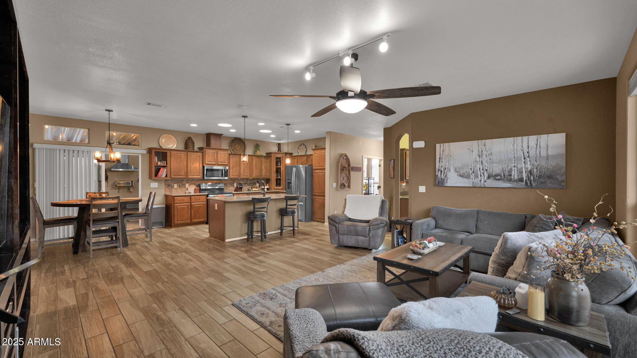 3301 South Goldfield Road, Unit 6014 Apache Junction, AZ 85119 - Photo 13 of 57 a living room with couches and kitchen view with wooden floor