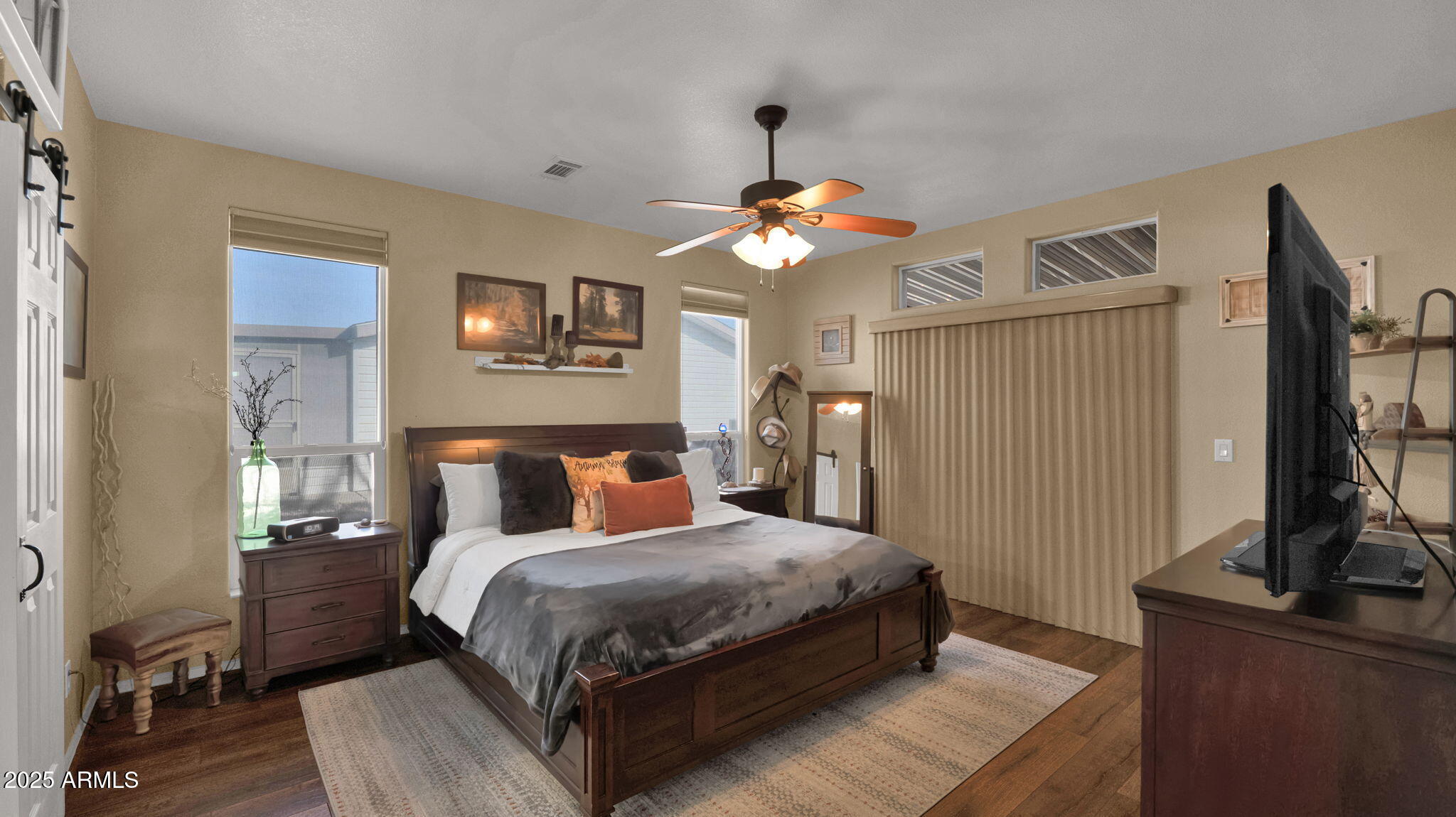 3301 South Goldfield Road, Unit 6014 Apache Junction, AZ 85119 - Photo 14 of 57 a bedroom with a bed flat screen tv and a window