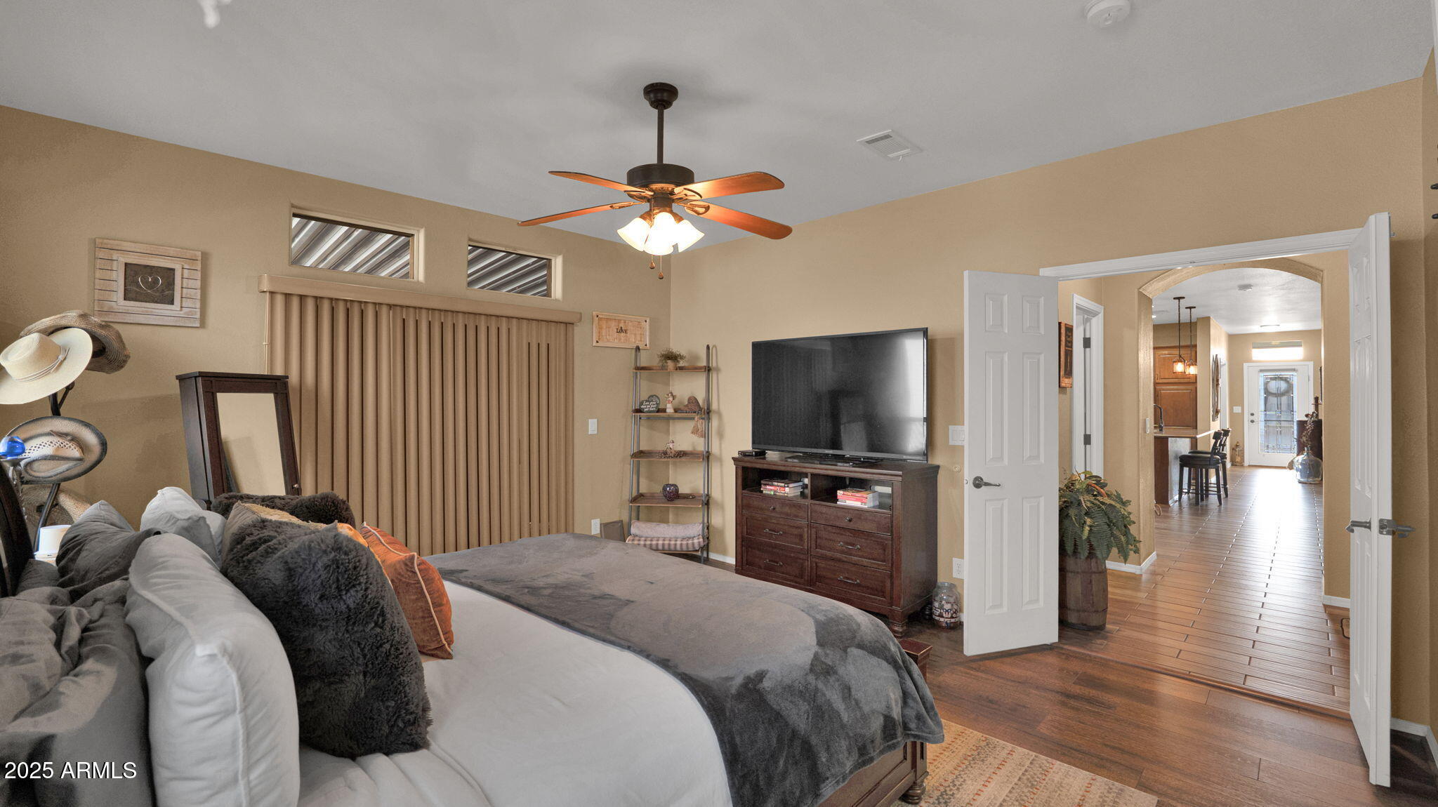 3301 South Goldfield Road, Unit 6014 Apache Junction, AZ 85119 - Photo 16 of 57 a bedroom with a bed and a flat tv screen on dresser