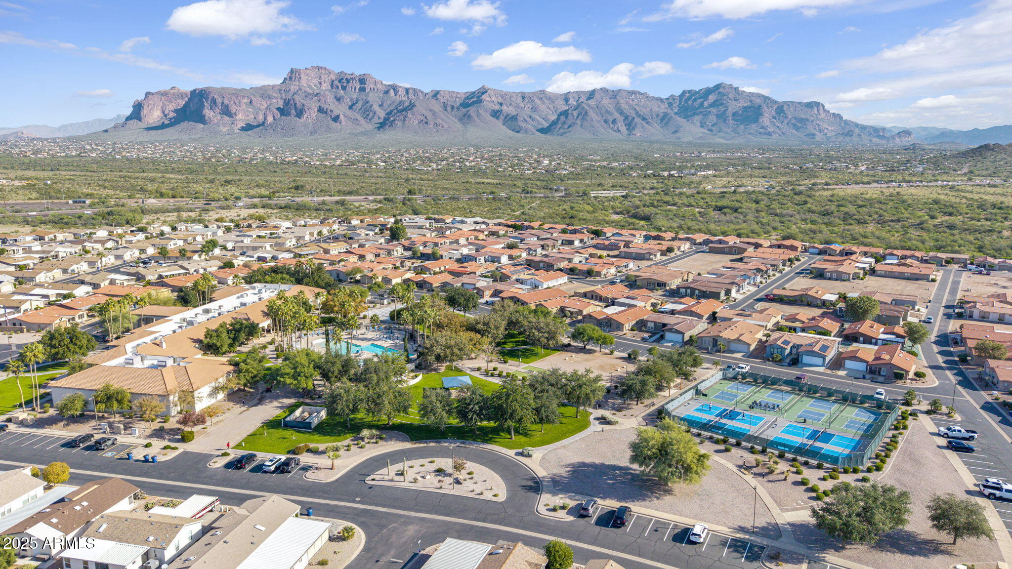 3301 South Goldfield Road, Unit 6014 Apache Junction, AZ 85119 - Photo 48 of 57 an aerial view of residential houses with outdoor space