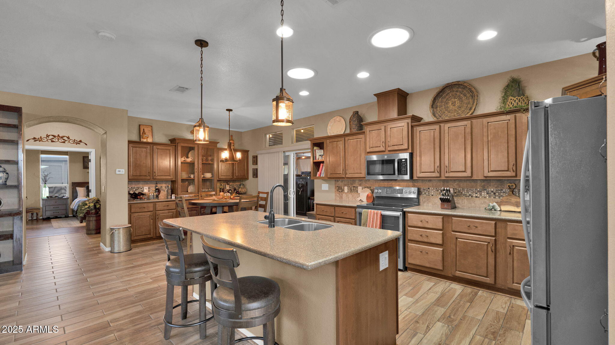3301 South Goldfield Road, Unit 6014 Apache Junction, AZ 85119 - Photo 6 of 57 a kitchen with stainless steel appliances kitchen island granite countertop a sink and cabinets