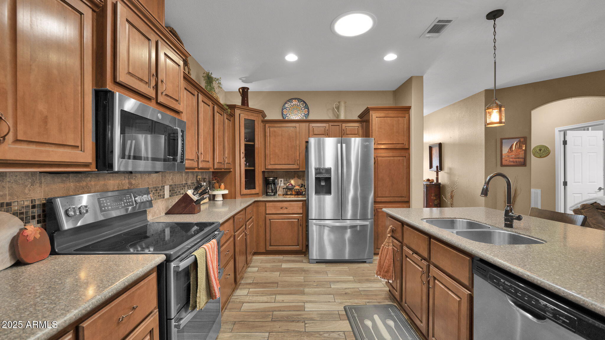 3301 South Goldfield Road, Unit 6014 Apache Junction, AZ 85119 - Photo 7 of 57 a kitchen with stainless steel appliances granite countertop a sink a stove and a refrigerator