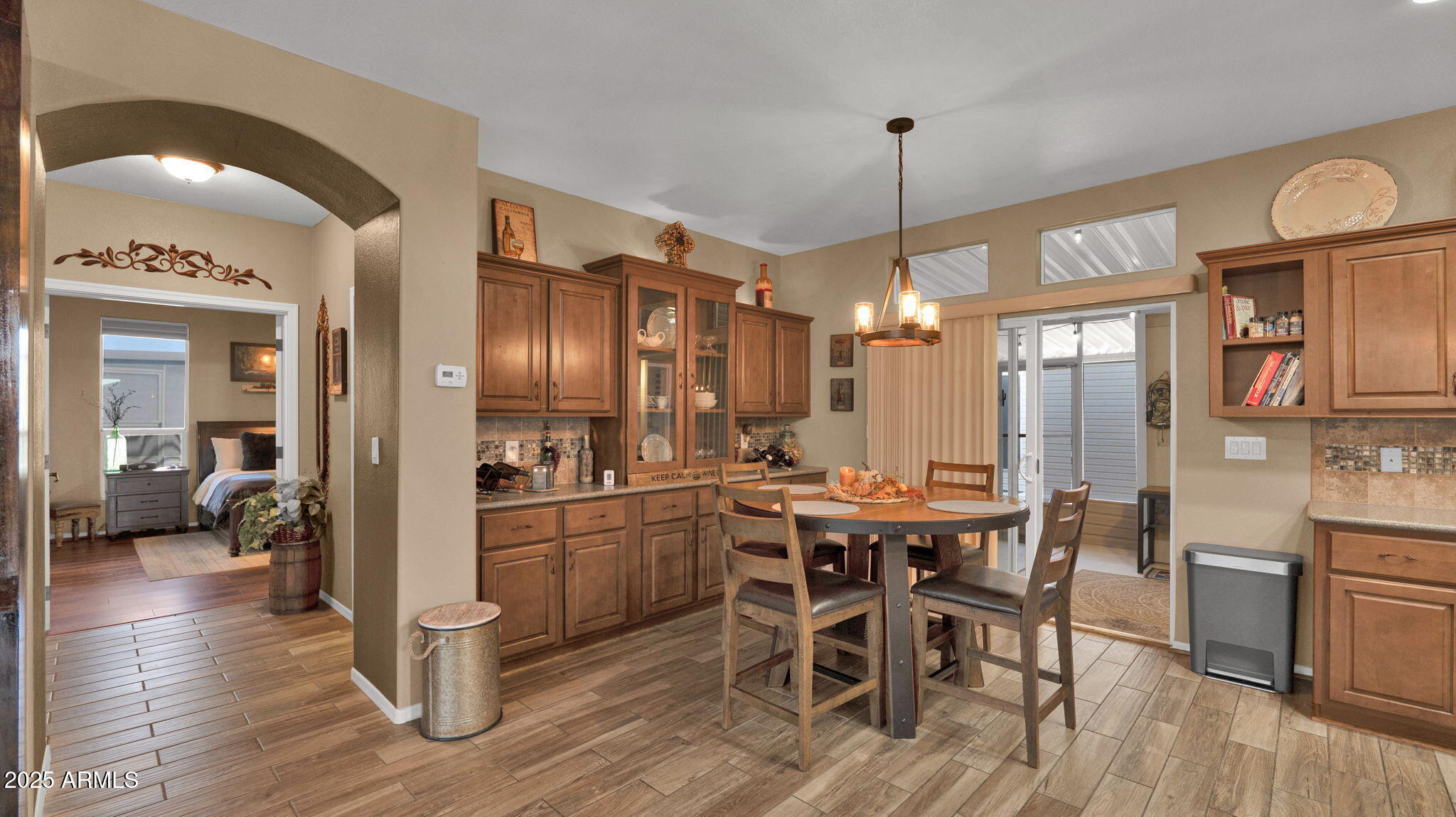 3301 South Goldfield Road, Unit 6014 Apache Junction, AZ 85119 - Photo 9 of 57 a view of a dining room with furniture window and wooden floor