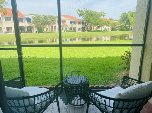 a view of an outdoor dining space with furniture and garden