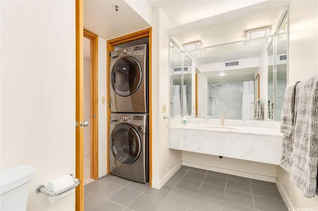a view of a bathroom with washing machine and chandelier