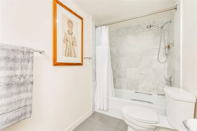 a bathroom with a shower a toilet and a shower