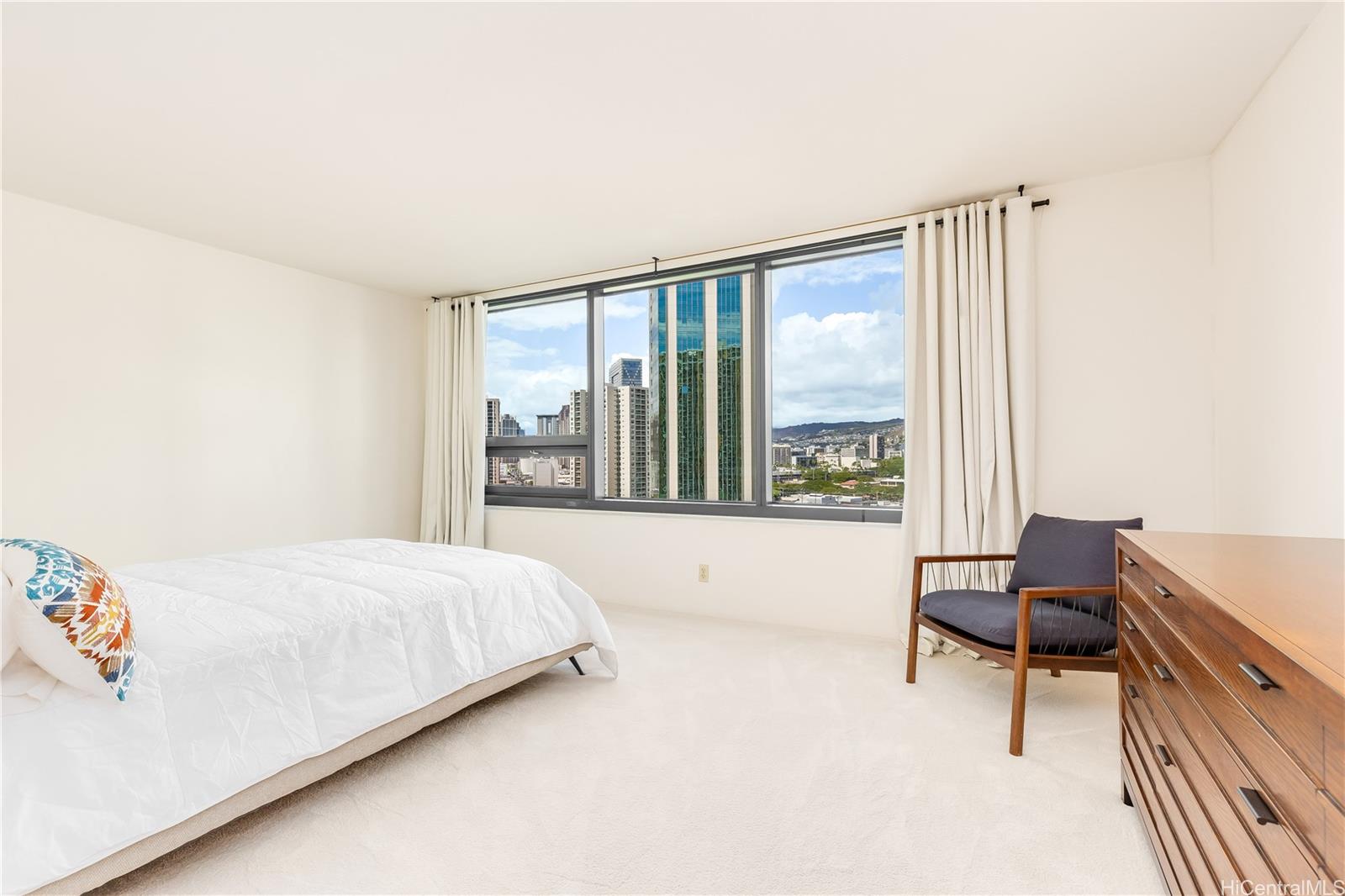 1330 Ala Moana Boulevard, Unit 1308 Honolulu, HI 96814 - Photo 13 of 24 a bedroom with a bed and a large window