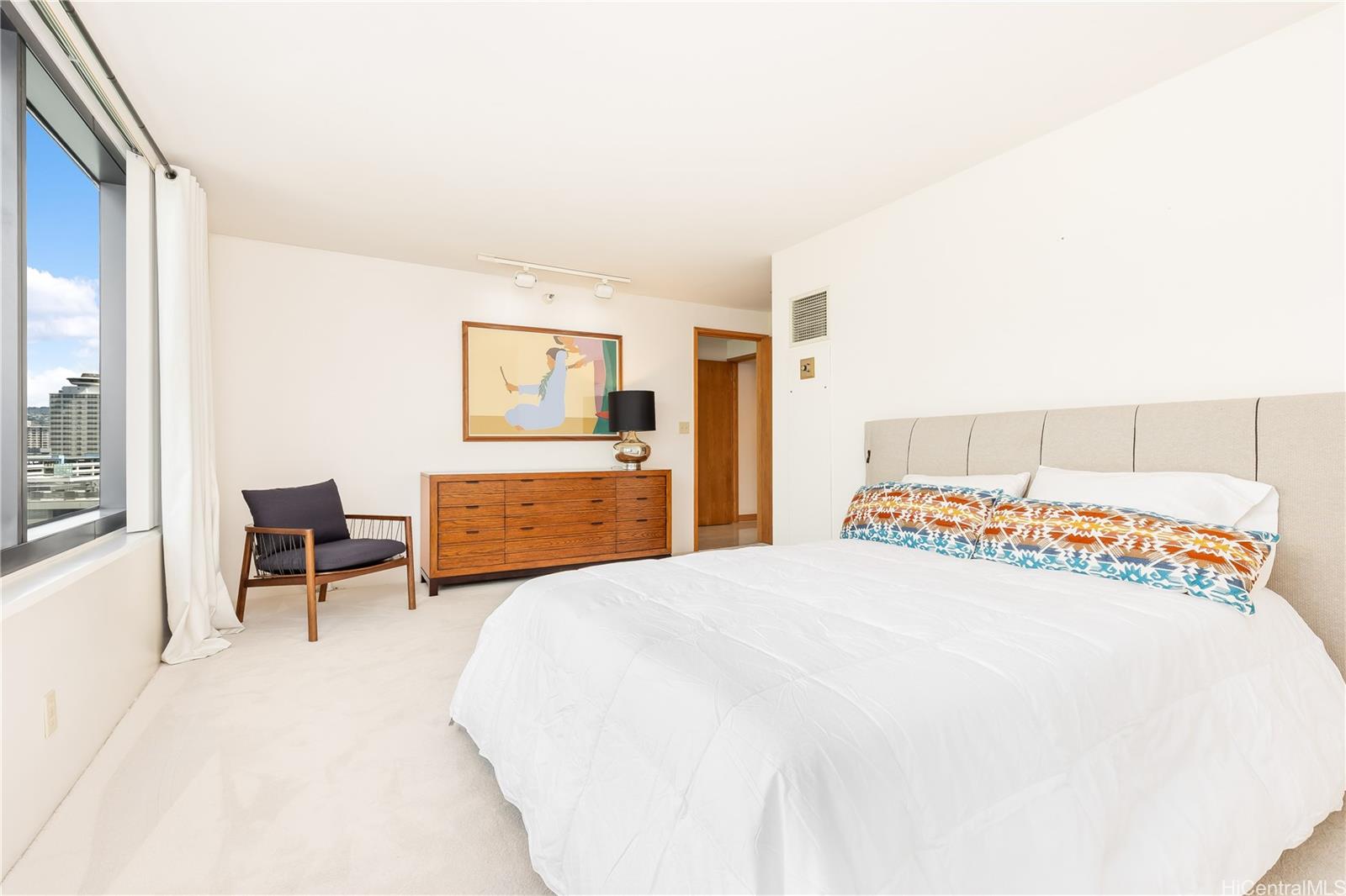 1330 Ala Moana Boulevard, Unit 1308 Honolulu, HI 96814 - Photo 14 of 24 a bedroom with a bed and a table