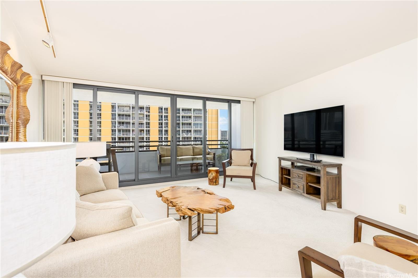 1330 Ala Moana Boulevard, Unit 1308 Honolulu, HI 96814 - Photo 3 of 24 a living room with furniture and a flat screen tv