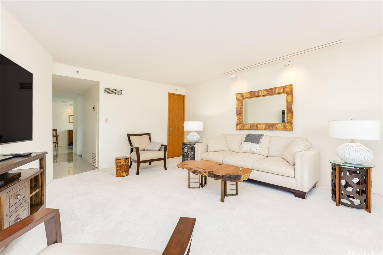 1330 Ala Moana Boulevard, Unit 1308 Honolulu, HI 96814 - Photo 4 of 24 a living room with furniture and a flat screen tv