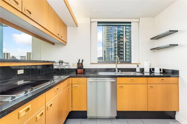 a kitchen with granite countertop a sink and a window