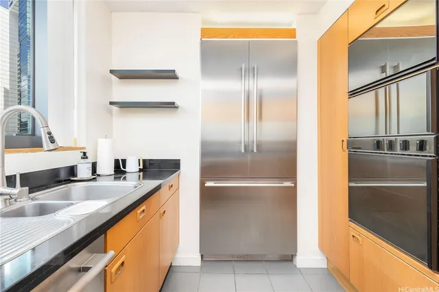 a kitchen with stainless steel appliances granite countertop a refrigerator and a sink