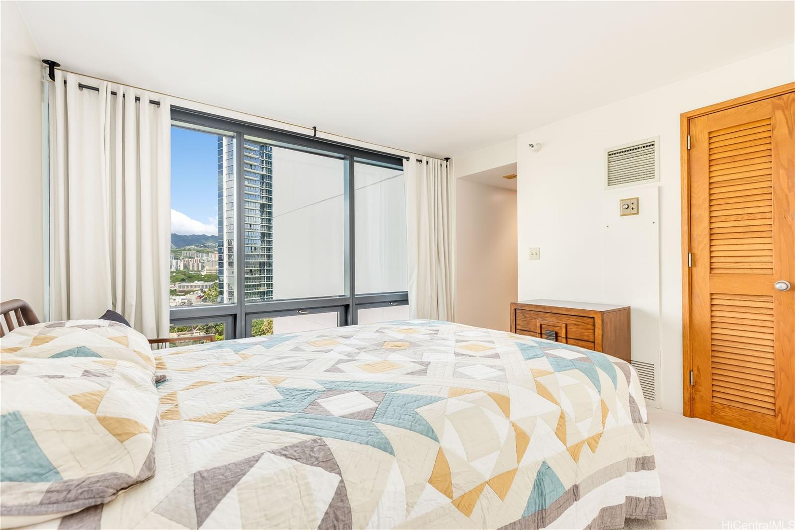 1330 Ala Moana Boulevard, Unit 1308 Honolulu, HI 96814 - Photo 10 of 24 a bedroom with a large bed and a large window