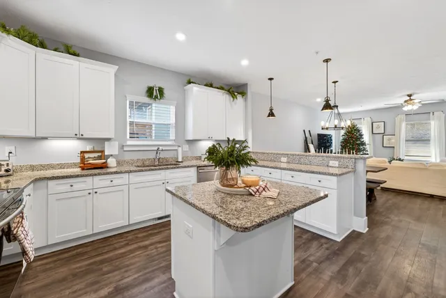 a kitchen with stainless steel appliances granite countertop refrigerator sink and cabinets