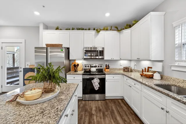 a kitchen with a sink a stove and cabinets