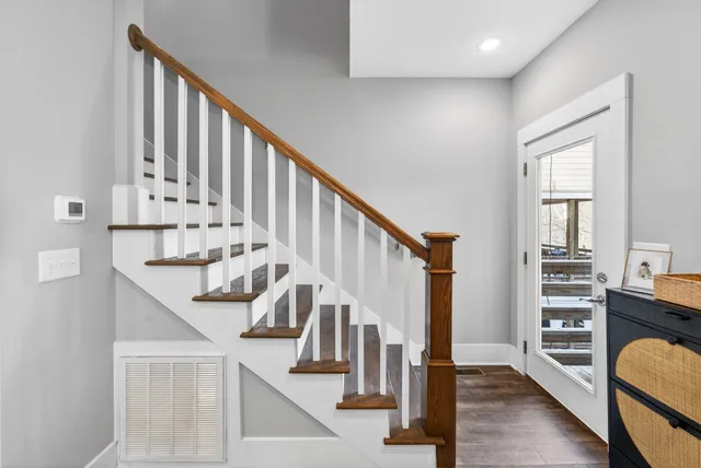a view of entryway and hall with wooden floor