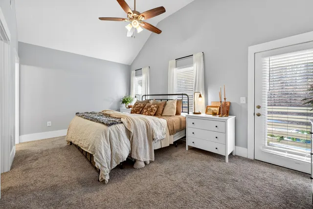 a bedroom with a bed dresser and a window
