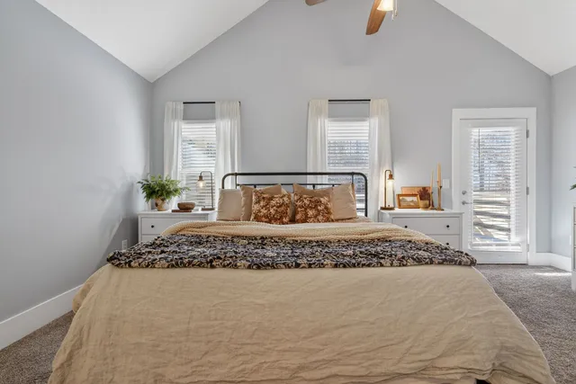 a bedroom with a large bed and a window